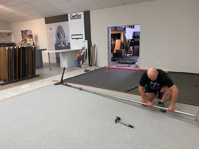 Man installing new carpet